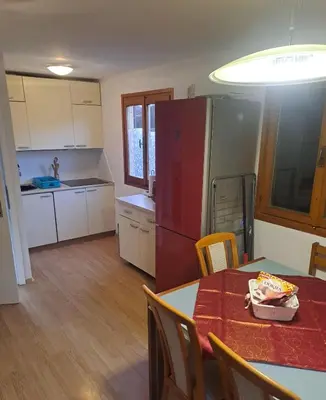 a kitchen with a table and a red refrigerator at Green Sky House in Mostec
