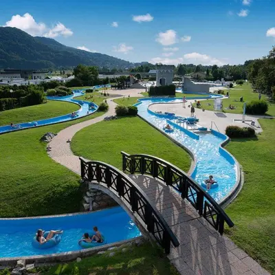 a bridge over a water park with people in water slides at Green Sky House in Mostec