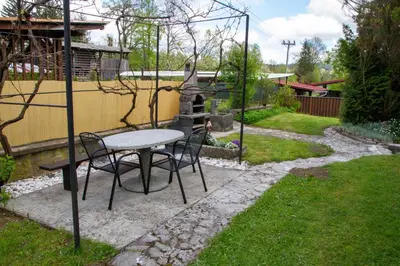 a table and chairs sitting in a garden at Apartma pri Klari in Kočevje