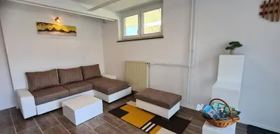 a living room with a couch and a table at Apartma pri Klari in Kočevje