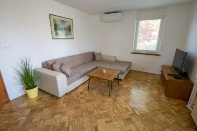 a living room with a couch and a table at Apartma pri Klari in Kočevje