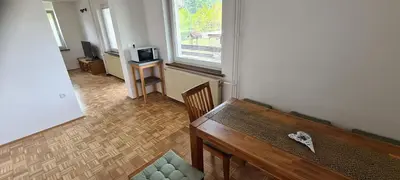 a living room with a bench and a window at Apartma pri Klari in Kočevje