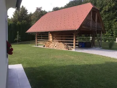 a large wooden cabin with a red roof at Sweet Retreat in Trebelno
