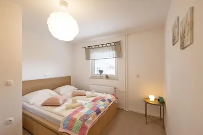 a small bedroom with a bed with a window at Apartma Jana in Žirovnica