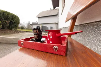 a red box with shoes in it on a porch at Apartma Jana in Žirovnica