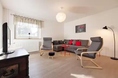 a living room with a couch and two chairs at Apartma Jana in Žirovnica