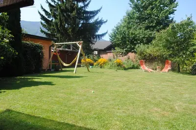 a yard with two chairs and a swing at Apartments Bogdanovic in Maribor