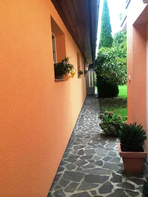 a hallway of an orange building with plants on the side at Apartments Bogdanovic in Maribor