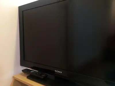 a sony television on a stand with a remote control at Apartments Bogdanovic in Maribor