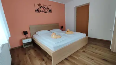 a bedroom with a bed with two stuffed animals on it at Apartment Irena Bovec in Bovec