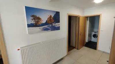 a bathroom with a painting hanging on a wall at Apartment Irena Bovec in Bovec