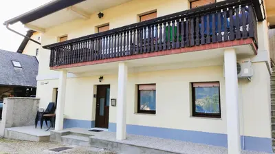 a house with a balcony on top of it at Apartment Irena Bovec in Bovec