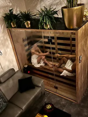 two men are in tubs in a room at JUNGLE Wellness Apartment in Trzin