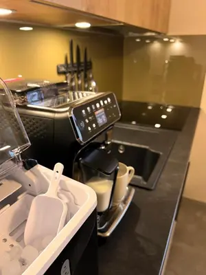a kitchen with a sink and a counter top at JUNGLE Wellness Apartment in Trzin