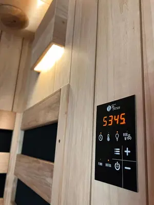 a sign on a wooden door with a clock on it at JUNGLE Wellness Apartment in Trzin