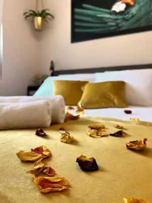 a bed with some leaves on the floor with a bed at JUNGLE Wellness Apartment in Trzin