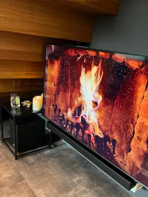 a flat screen tv sitting on top of a fireplace at JUNGLE Wellness Apartment in Trzin