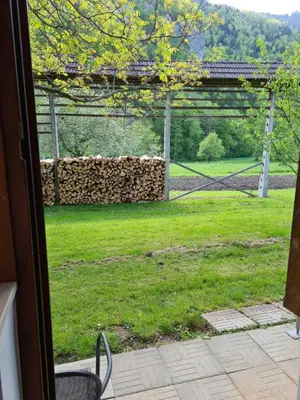 an open door to a yard with a fence at Gostilna Batišt in Bohinjska Bela
