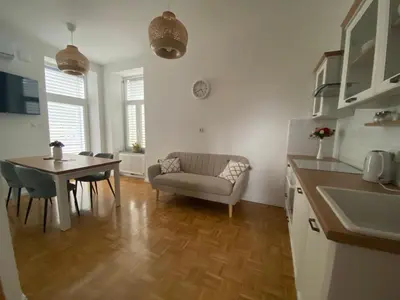 a kitchen and living room with a table and a couch at Apartma ROGATEC in Rogatec