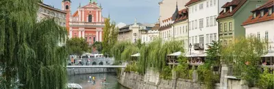 a bridge over a river in a city with buildings at Nick & Klaras Central Apartments in Ljubljana