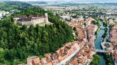 an aerial view of a town with a river and a castle at Nick & Klaras Central Apartments in Ljubljana