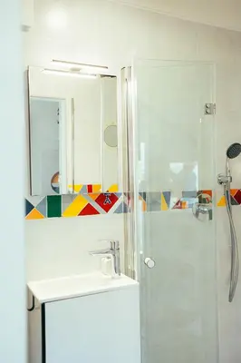 a bathroom with a shower and a sink and a mirror at ArtRock Studio in Radovljica
