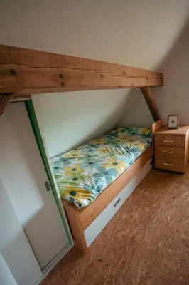 a bedroom with a bunk bed and a dresser at KAJZA KOLOVRAT in Mozirje
