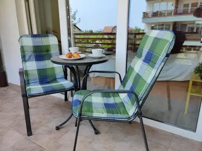 two chairs and a table on a patio at Apartment Marusa in Moravske Toplice