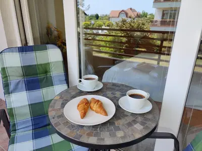 a table with two cups of coffee and croissants at Apartment Marusa in Moravske Toplice
