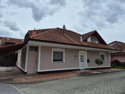 a small white house with a red roof at Oddih v mirnem in zelenem okolju in Škofljica