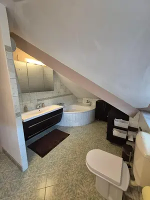 a bathroom with a toilet and a sink and a tub at Oddih v mirnem in zelenem okolju in Škofljica