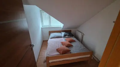 a small bed with pillows on it in a attic at Oddih v mirnem in zelenem okolju in Škofljica