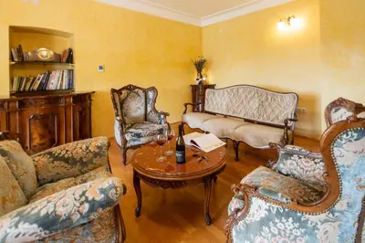 a living room with a couch and chairs and a table at Herga Wine Estate - Old lady - Holiday Home in Ivanjkovci