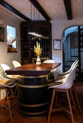 a wine tasting room with a barrel table and chairs at Herga Wine Estate - Nest above wine cellar - rooms in Ivanjkovci