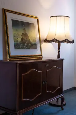 a lamp on top of a dresser with a picture at Herga Wine Estate - Nest above wine cellar - rooms in Ivanjkovci