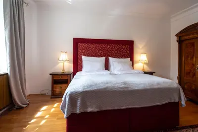 a bedroom with a large bed with two lamps at Herga Wine Estate - Nest above wine cellar - rooms in Ivanjkovci