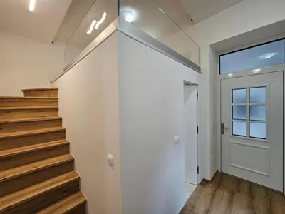 a staircase in a house with a window and a door at Studio Apartment Sviti TourAs by Town Hall in Ljubljana