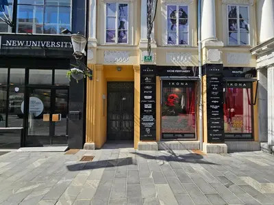 a building with signs on it on a city street at Studio Apartment Sviti TourAs by Town Hall in Ljubljana