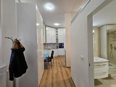 a hallway with a dining room and a kitchen with a table at Studio Apartment Sviti TourAs by Town Hall in Ljubljana