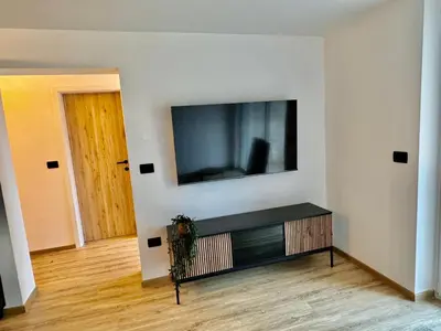 a living room with a flat screen tv on a wall at Nur Apartment in Bled