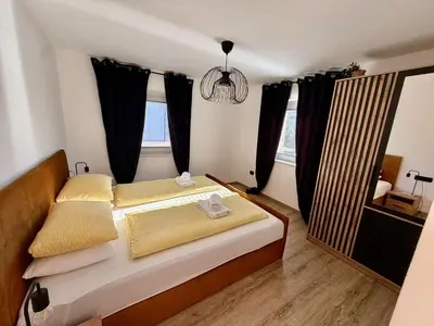 a bedroom with a bed with black curtains at Nur Apartment in Bled