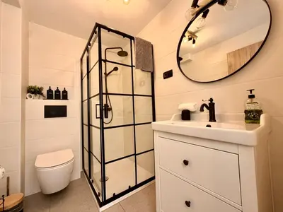 a bathroom with a toilet and a sink and a mirror at Nur Apartment in Bled