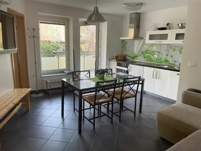 a kitchen and dining room with a table and chairs at Apartments Rose in winter in Bled
