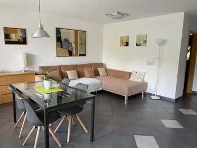 a living room with a couch and a table at Apartments Rose in winter in Bled