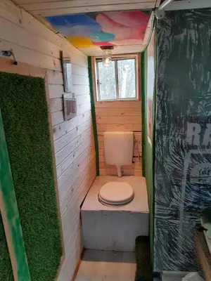 a small bathroom with a toilet in a house at Tree house Ramona & Fairytale wooden house by Ljubljana in Grosuplje