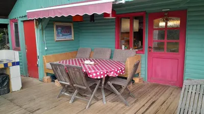 a table and chairs sitting outside of a house at Tree house Ramona & Fairytale wooden house by Ljubljana in Grosuplje