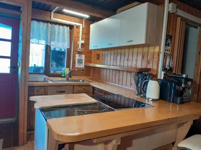 a kitchen with a sink and a counter top at Tree house Ramona & Fairytale wooden house by Ljubljana in Grosuplje
