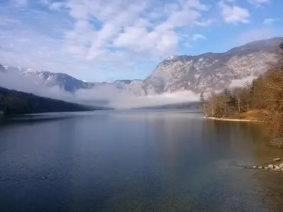 a view of a lake with mountains in the background at Hiška Henrik Zalokar in Bohinj