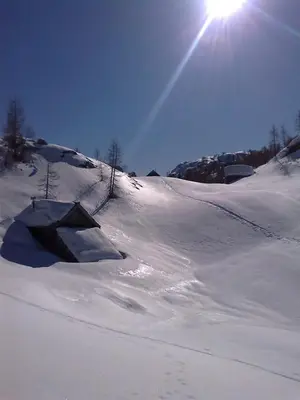 a snow covered slope with a ramp in the snow at Hiška Henrik Zalokar in Bohinj