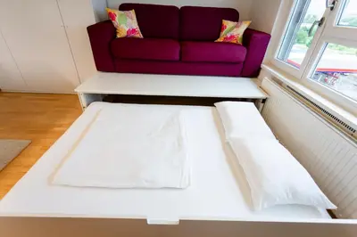 a living room with a couch and a table at Cute Tiny Flat in Ljubljana